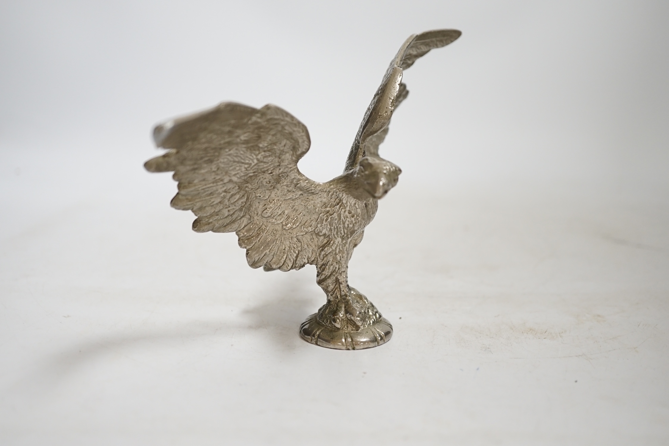 A mid 20th century chromed metal Eagle car mascot, 18cm wide. Condition - fair